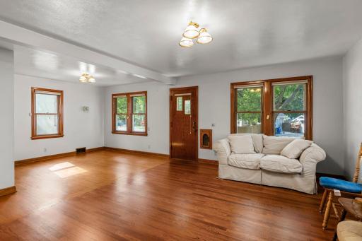 Windows bring in a ton of natural light and highligh the hardwood floors.