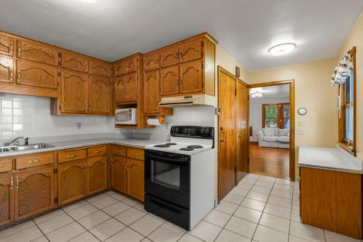 Generous counter space and timeless ceramic tile floors enhance the kitchen.