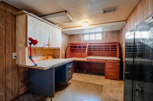 Den area partially finished in lower level is a great flex space, workshop or office.