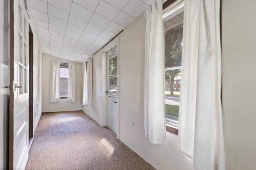 A charming front porch welcomes visitors! Envision this space with thoughtful storage decor, plants, and a small table for coffee or reading