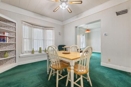 Bay window lets in natural light and adds a decorative element to the dining area