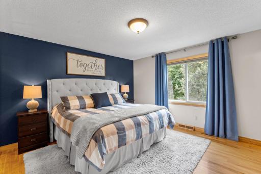 Large primary bedroom overlooking the backyard