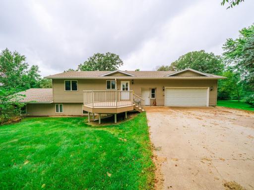 Maintenance free deck off of the front of the house with an attached garage