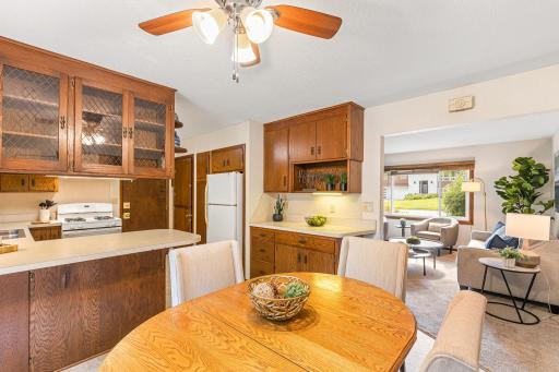 Dining room adjoins kitchen with glass front cabinets