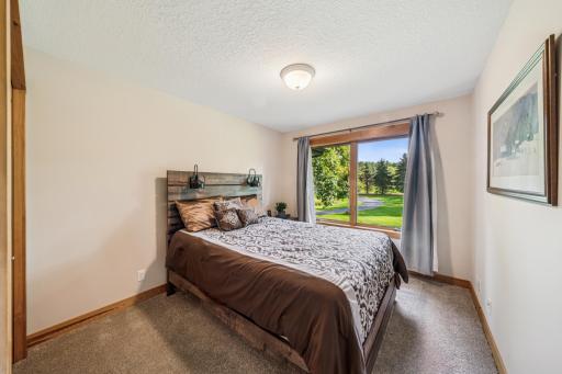 One of four main floor bedrooms overlooks the front yard.