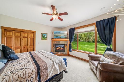 The lower level bedroom offers a serene and scenic view of the back yard.