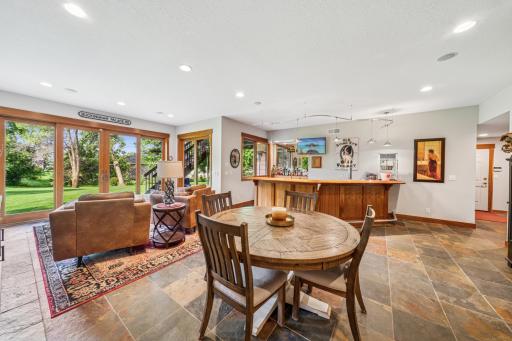 Spacious entertainment space with a beautiful, custom bar, and an open floor plan offering an assortment of seating options!