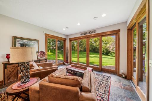 The lower level walk-out presents a wall of windows which flood the entertainment area with an abundance of natural light. A set of patio doors lead to one of several spaces for outdoor enjoyment.