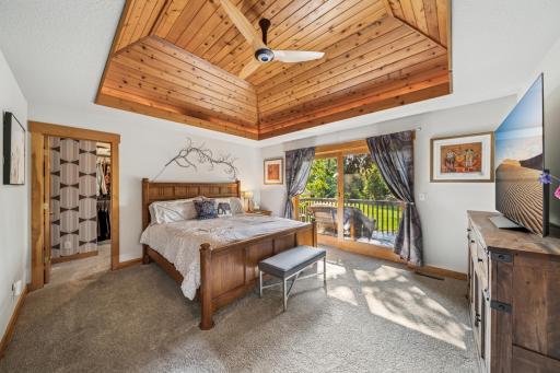 The primary bedroom is spacious and has a unique vaulted ceiling accent. This sanctuary offers you a generous walk-in closet, a private balcony overlooking a beautiful waterfall feature, and a gorgeous spa-level ensuite bath.