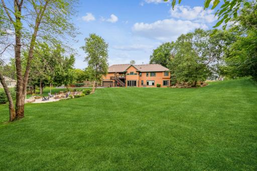 View of the back of the home. Note the two additional tuck-under parking stalls offering even more storage for all your toys! This provides you with five garage stalls plus additional storage space!!!!