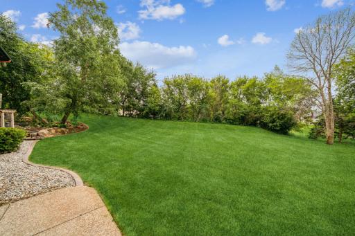 Mature landscaping combined with an expanse of lush green lawn, connects the inside of the home with the great outdoors.