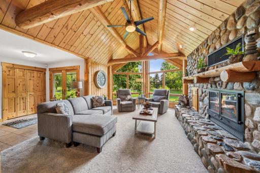 Welcome to this serene and welcoming front room with a vaulted ceiling and a gorgeous wood-burning fireplace.