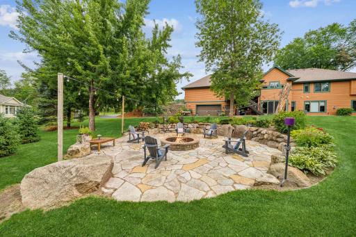 The beautiful natural stone-paver firepit has been designed for socializing and seasonal entertaining.