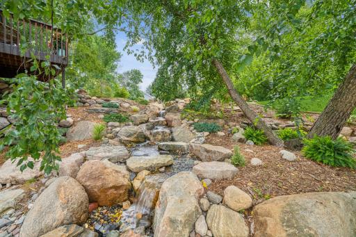 As night falls, you can fall asleep to the sounds of the melodic, babbling waterfall thoughtfully installed just outside the primary bedroom and bath.