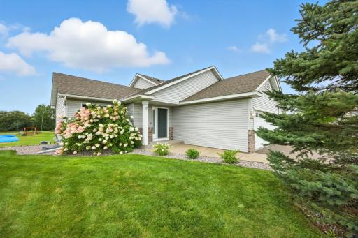 Great curb appeal highlights a gorgeous hydrangea bush, currently full of flowers!
