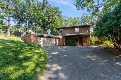 Set on nearly half an acre of a wooded corner lot in a desirable Edina neighborhood, this four-bedroom home offers a rare combination of space, character, and convenience.