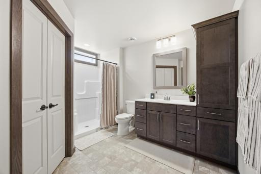 Primary Bathroom - very spacious, with seamless granite-composite sink & countertop and LOTS of cabinetry