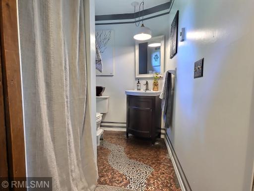 Main floor 3/4 bath has a cool epoxied floor made out of change.