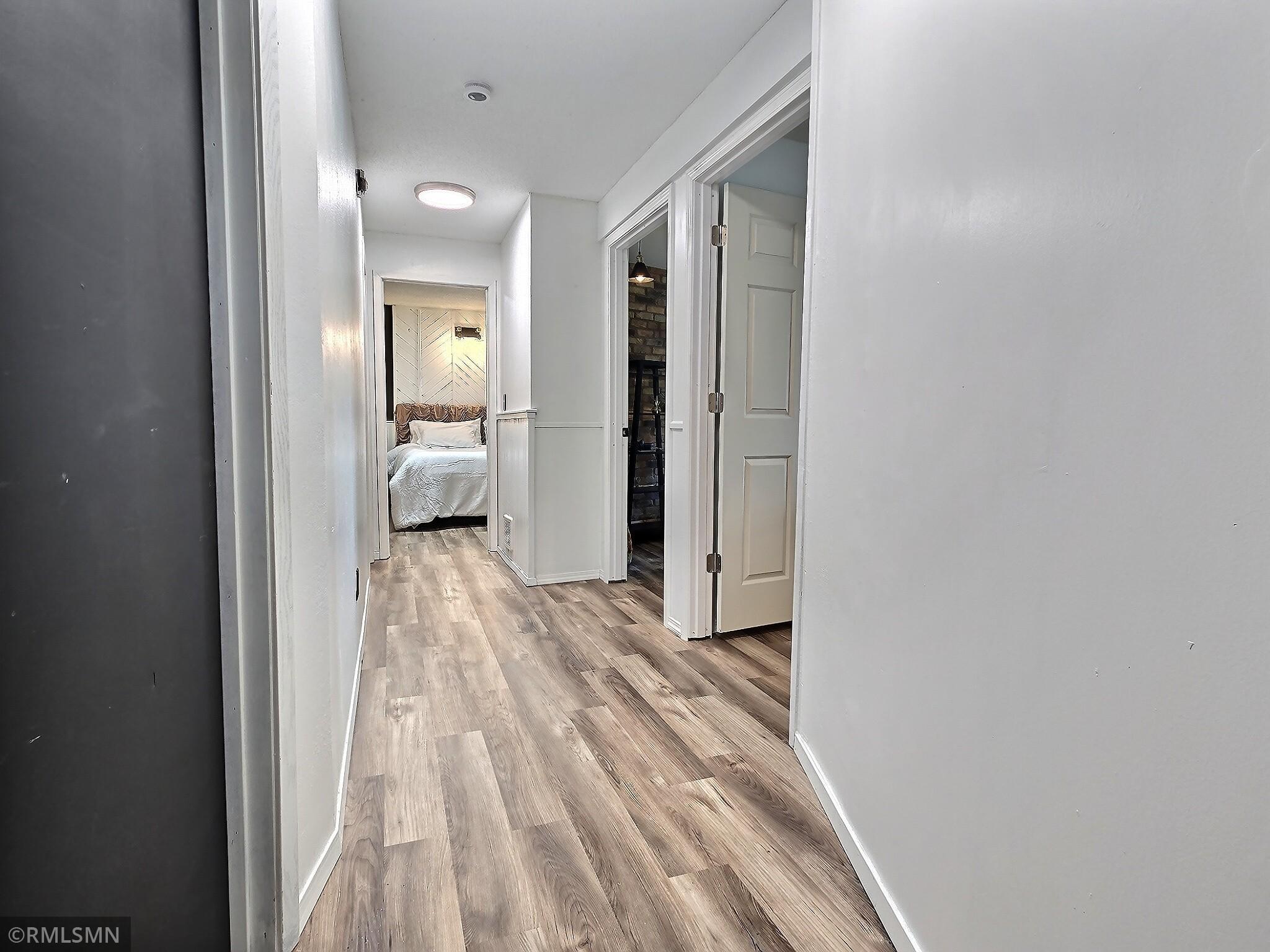As you enter the lower level notice brand new luxury vinyl plank flooring