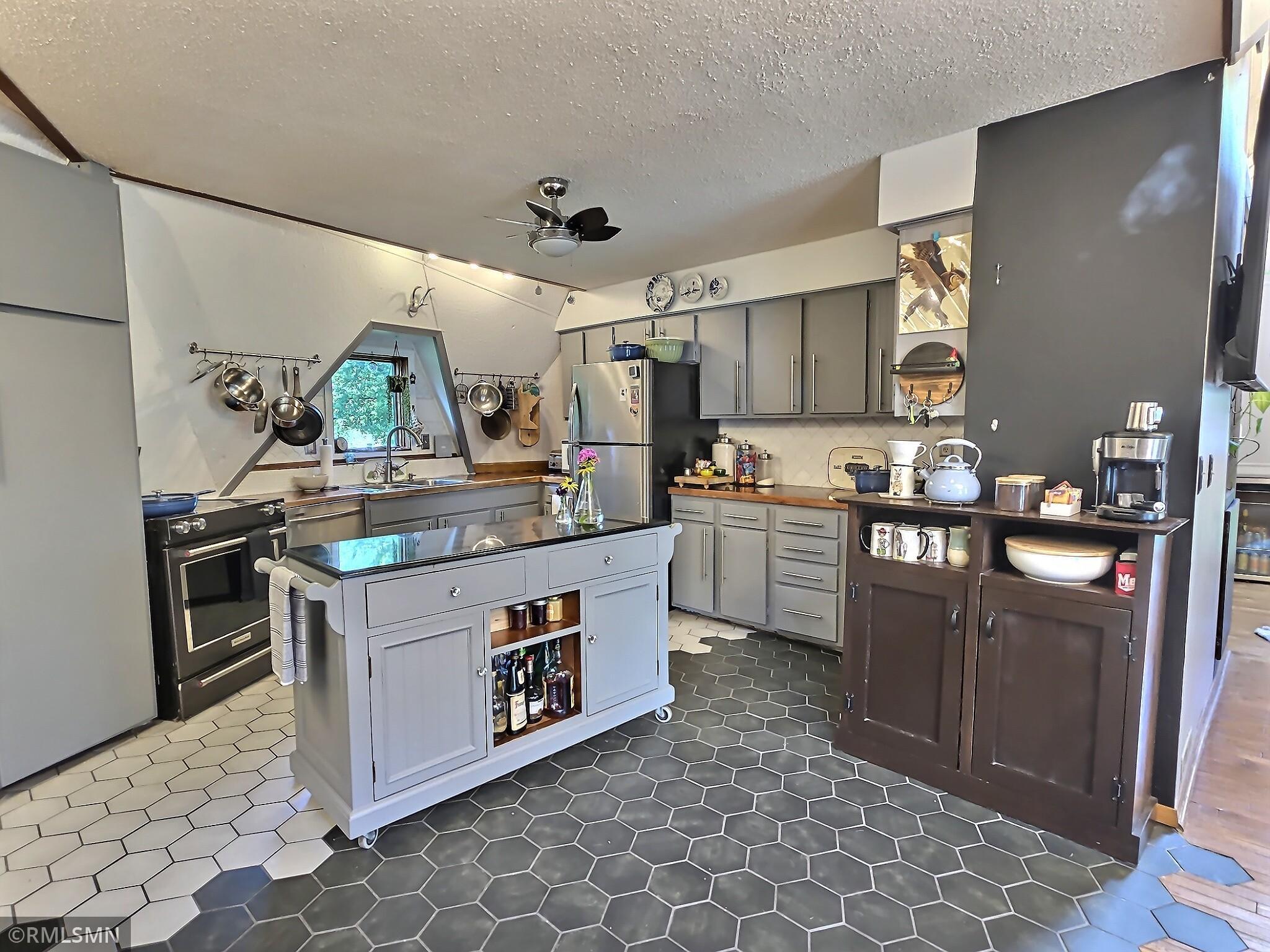 Inside you'll see a transition from hardwood to tile as you enter the kitchen