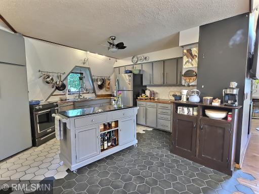 Inside you'll see a transition from hardwood to tile as you enter the kitchen