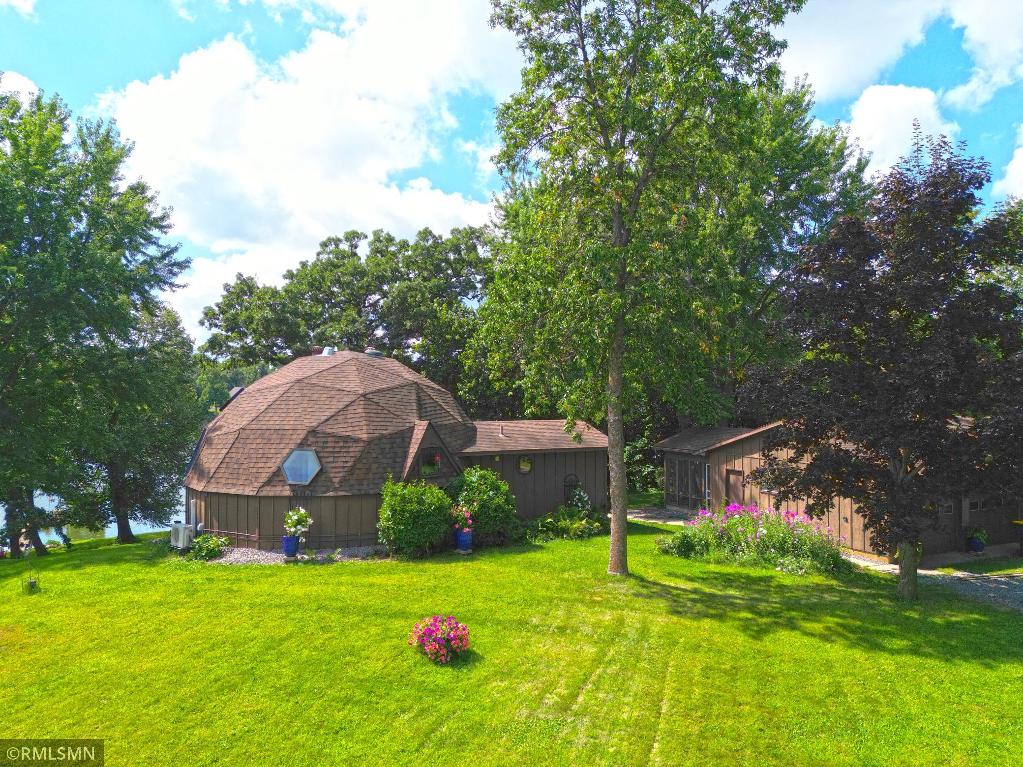 View of the back of the home showing more of the triangle design. Detached 2 stall garage to the right