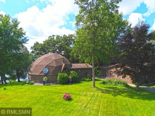 View of the back of the home showing more of the triangle design. Detached 2 stall garage to the right