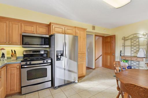 Sunlit Kitchen w/Ceramic Tile Flooring and Stainless Steel Appliances.