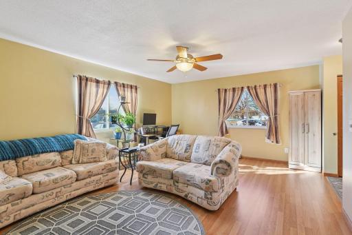 Living Room w/Laminate Flooring, Ceiling Fan & Updated Windows.