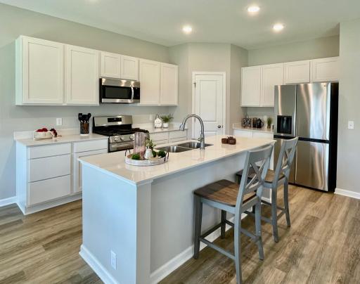 3218 Kady Ave NE- Kitchen features a spacious center island and corner walk-in pantry.