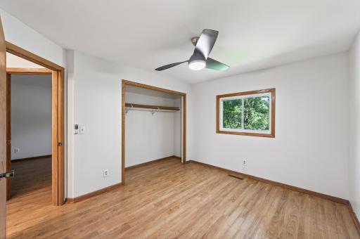 Second main level bedroom features lots of natural light, spacious closet, and ceiling fan.