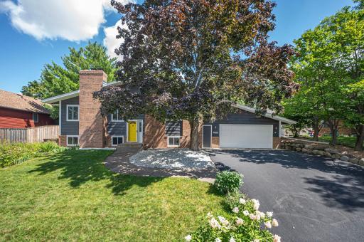 Welcome to 7892 Kingsview Lane N! Surrounded by gardens, trees, and a private backyard, this hilltop home is built for both relaxation and fun. Enjoy a three-season porch, deck, and space for play and entertaining.