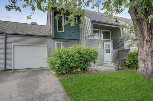 Step into this inviting townhouse featuring an open-concept main level with a cozy fireplace.