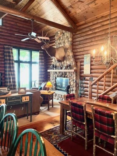 Main level looking across the open dining area to the great room and large windows with lake views