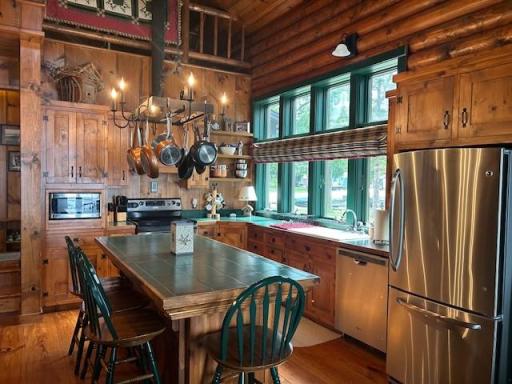 Terrific kitchen filled with light with huge windows over the counter and sink area. Center island is a great breakfast/lunch bar