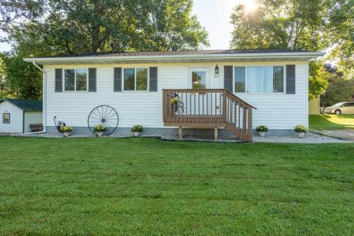 Front of home with vinyl siding and corner lot.