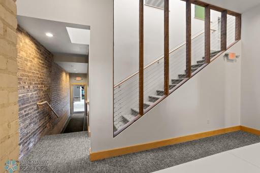 Main floor foyer and back entrance from Roberts Alley. Stairs lead to upper conference room/media room