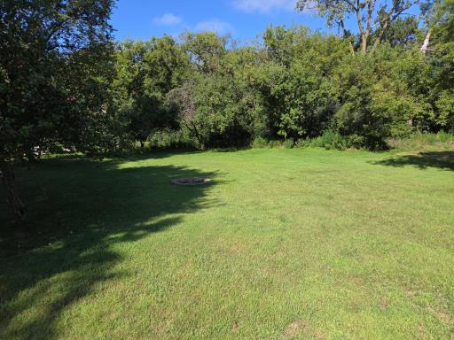 Manacured yard backingup to private wooded area.