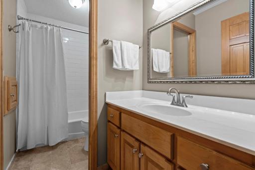 A full bath with tiled tub-shower and ample linen storage completes this level.