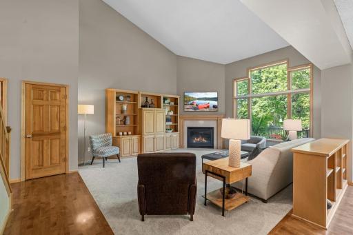 The great room, anchored by a cozy gas fireplace, features new carpet, a spacious entertainment center, and pre-wired surround soundâideal for both everyday living and entertaining.