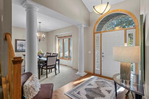 Step inside a welcoming foyer where 17-foot ceilings and classic hardwood floors set a tone of elegance.