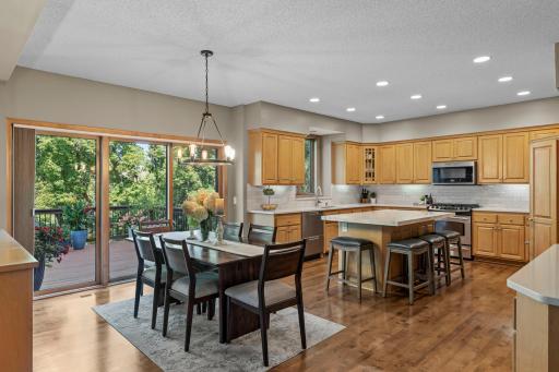 The informal dining area is brightened by a statement light fixture and sliding doors to the back deck.