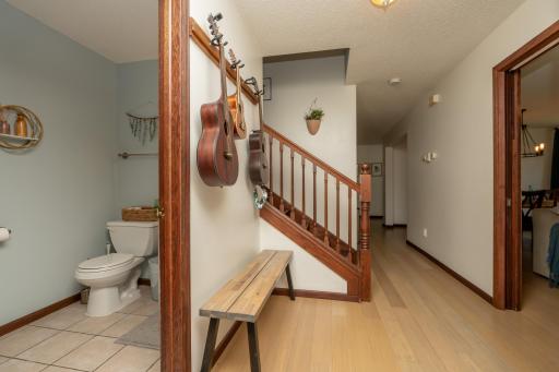 View from entry to 1/2 bath, hallway to upstairs, kitchen, living and dining room