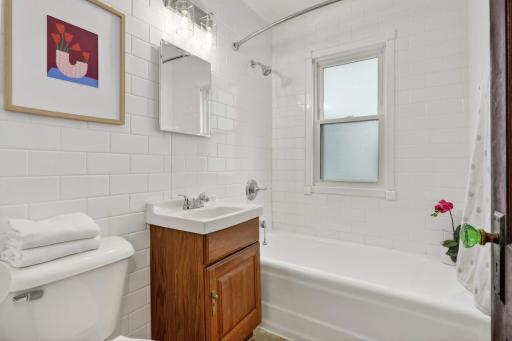 Main-level full bath with newly resurfaced tub.