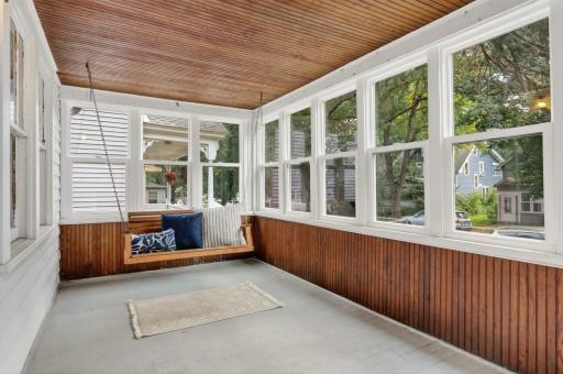 Front porch with newer Pella windows and classic porch swing.