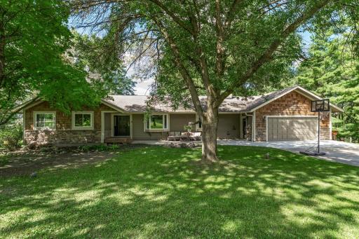 Tucked away on over 4 private, wooded acres, this beautiful home offers the peace and tranquility of country living while being just minutes from all the amenities of Prior Lake.