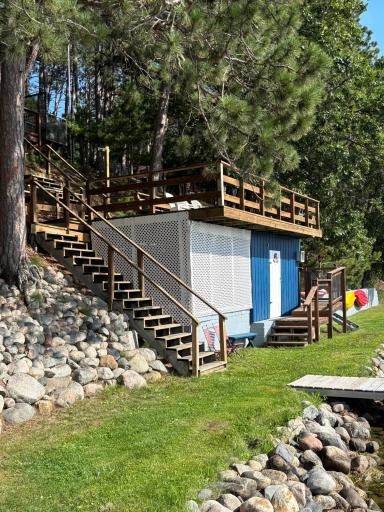 Large community deck on top of the beach house storage building. Stairs to the lake and Hill hiker on the other side of the building down to the lake.