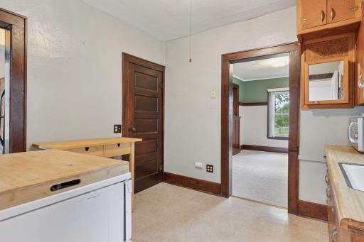 To the far left is the refridgerator niche and the other door goes to the full basement.