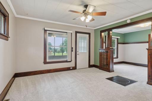 The living and dining areas have new carpet. The living room has a ceiling fan.