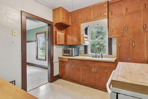 The kitchen has a nice window that looks out to the side yard and lots of cabinetry.